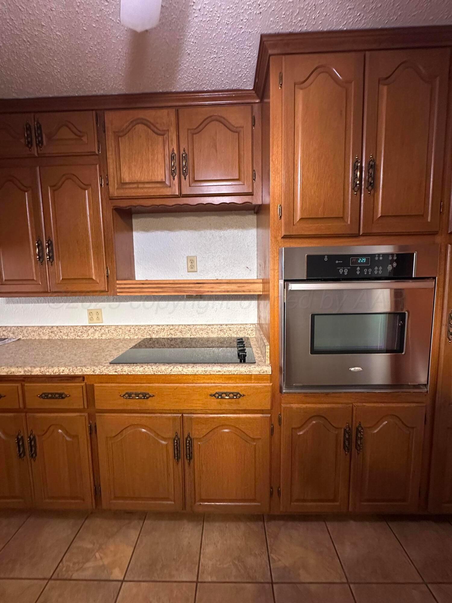 1007 Archer Street Spearman, TX 79081 - Photo 6 of 20 a stove top oven sitting inside of a kitchen