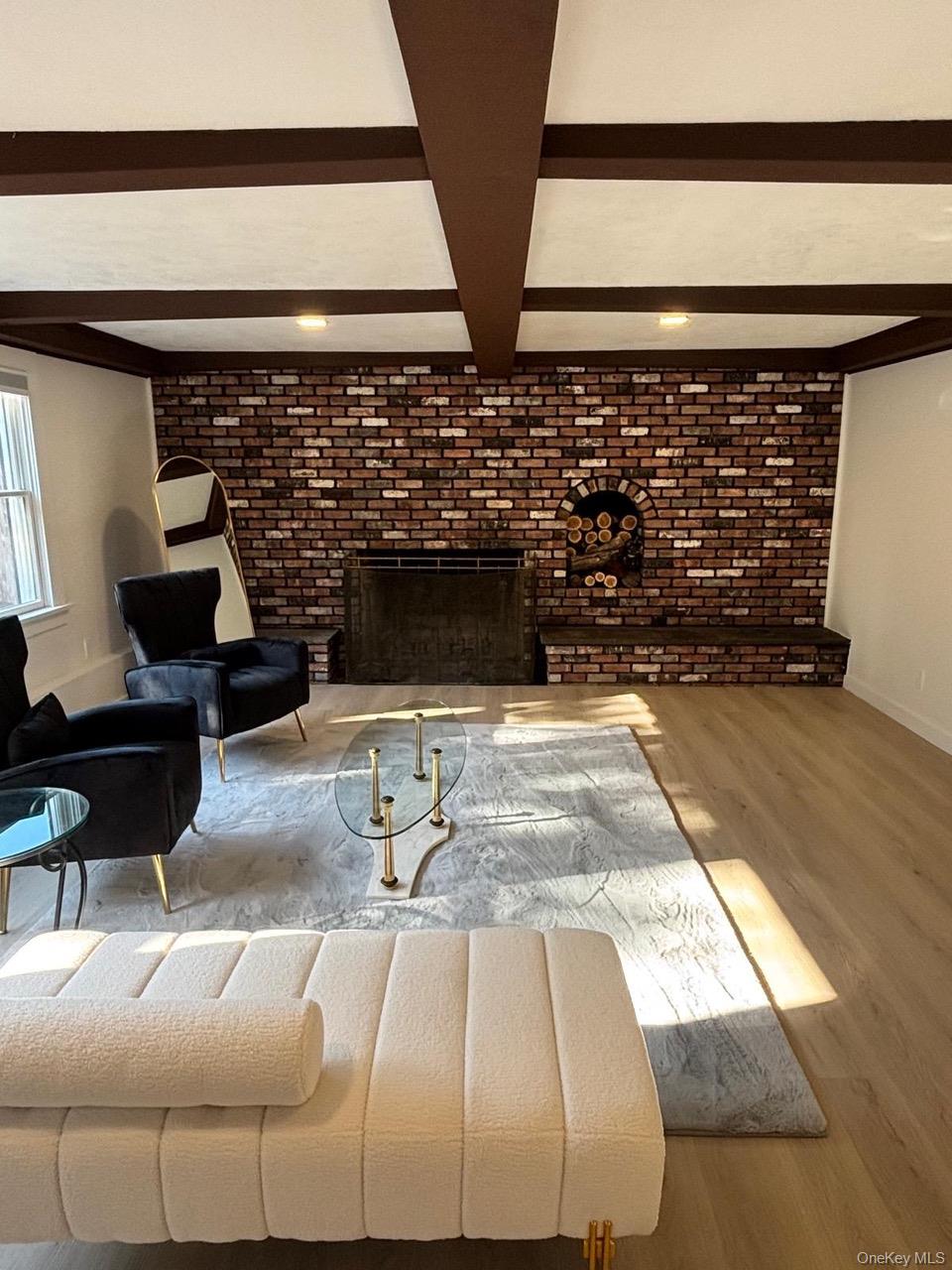 791 Longview Avenue Valley Stream, NY 11581 - Photo 13 of 33 Living area with a brick fireplace, wood finished floors, brick wall, and coffered ceiling