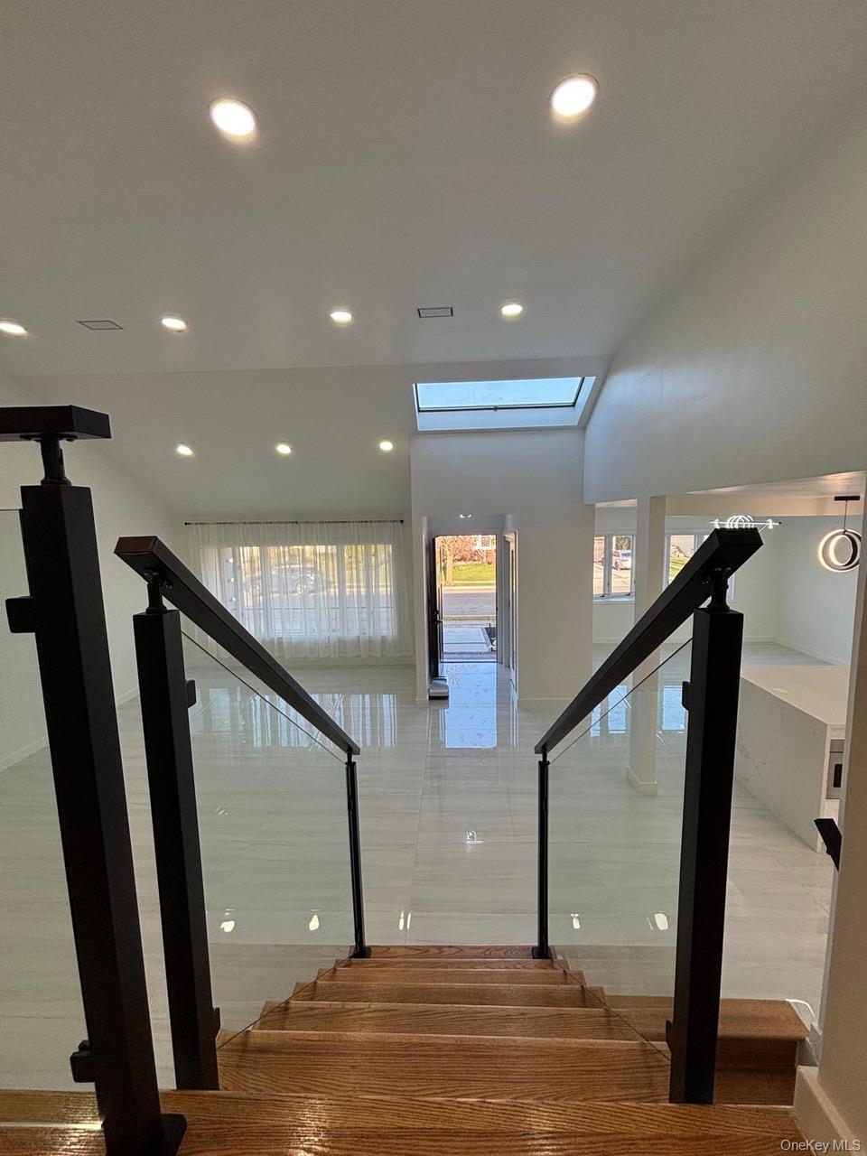 791 Longview Avenue Valley Stream, NY 11581 - Photo 25 of 33 Stairway featuring recessed lighting, a skylight, and wood finished floors