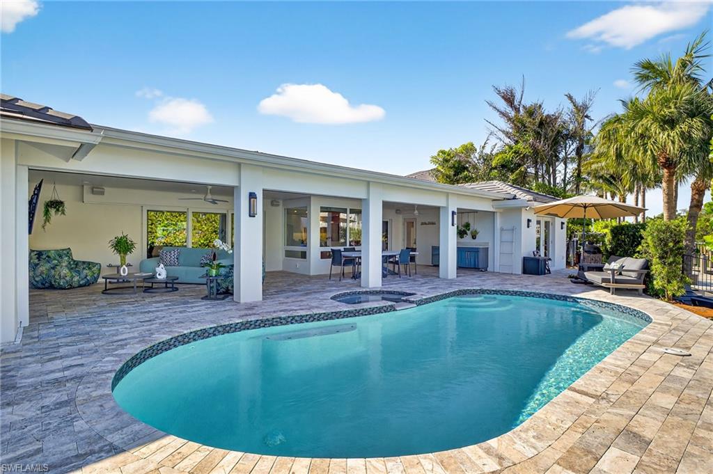 5215 Seashell Avenue Naples, FL 34103 - Photo 11 of 47 a view of a house with swimming pool and sitting area