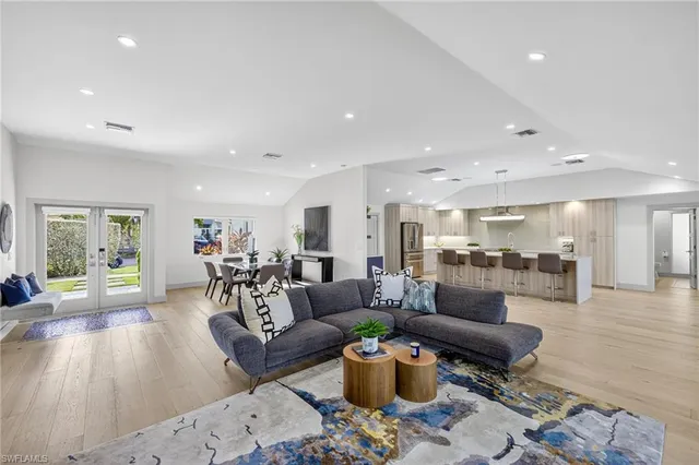 a kitchen with stainless steel appliances kitchen island granite countertop a refrigerator and a stove top oven