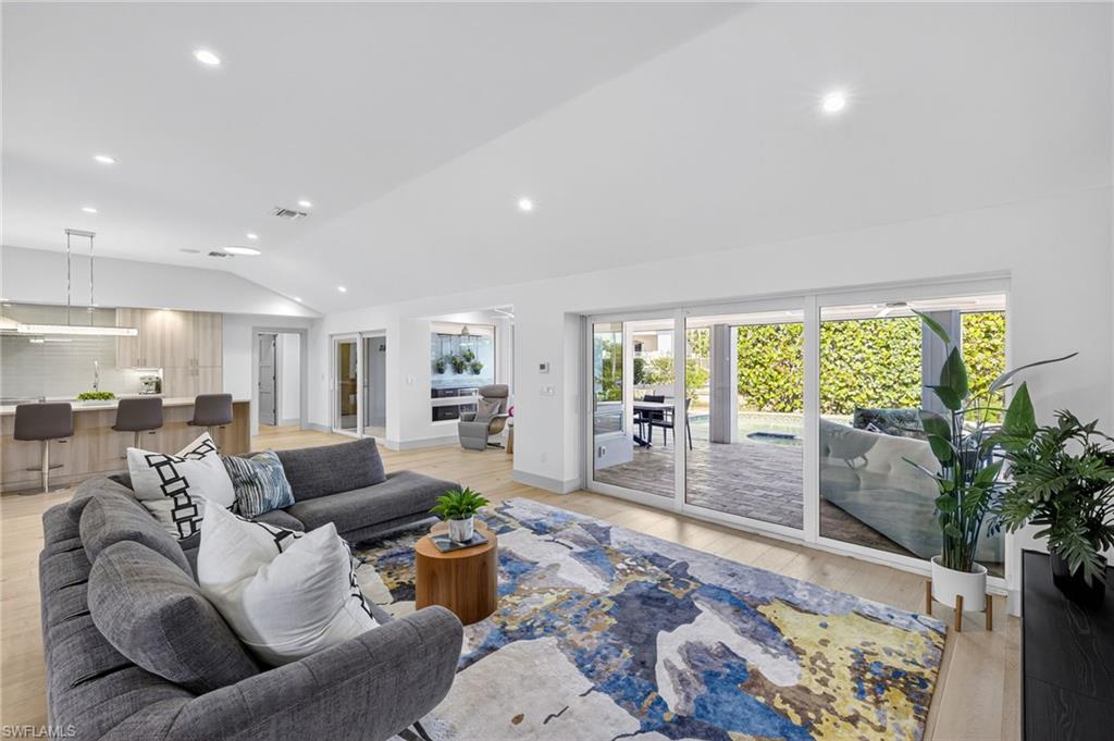 5215 Seashell Avenue Naples, FL 34103 - Photo 15 of 47 a living room with furniture and a large window