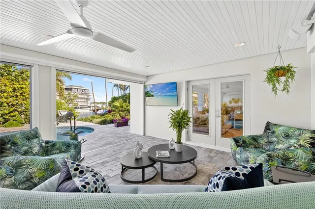 a living room with furniture and a potted plant