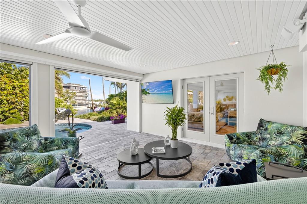 5215 Seashell Avenue Naples, FL 34103 - Photo 2 of 47 a living room with furniture and a potted plant