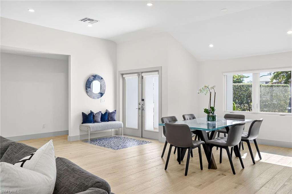 5215 Seashell Avenue Naples, FL 34103 - Photo 22 of 47 a living room with furniture and a large window