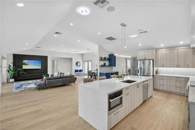 a spacious bedroom with a bed and a painting on the wall