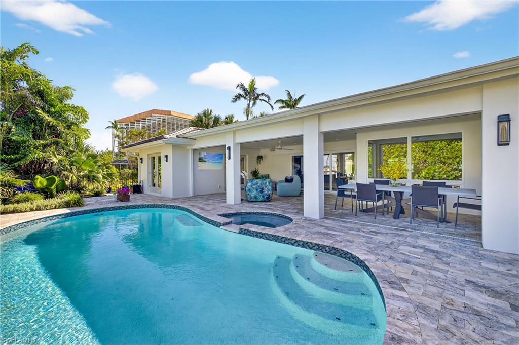 5215 Seashell Avenue Naples, FL 34103 - Photo 27 of 47 a view of a house with swimming pool and sitting area