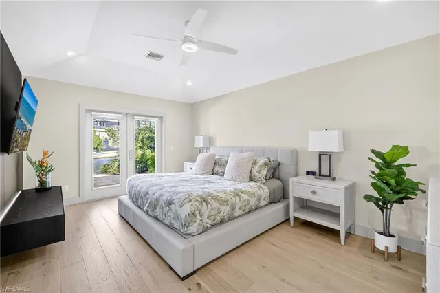 a spacious bedroom with a bed and a lamp