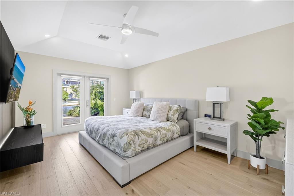5215 Seashell Avenue Naples, FL 34103 - Photo 29 of 47 a living room with a bed furniture flat screen tv and a large window