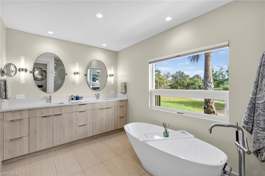 5215 Seashell Avenue Naples, FL 34103 - Photo 32 of 47 a bathroom with 2 sink and a mirror