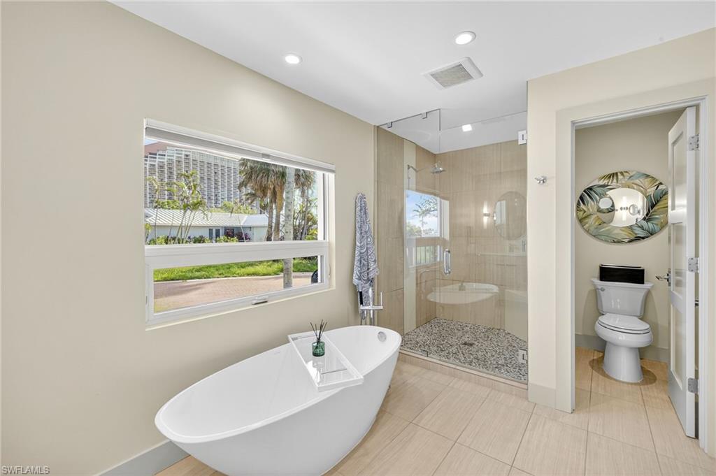 5215 Seashell Avenue Naples, FL 34103 - Photo 33 of 47 a bathroom with a granite countertop sink a toilet and shower