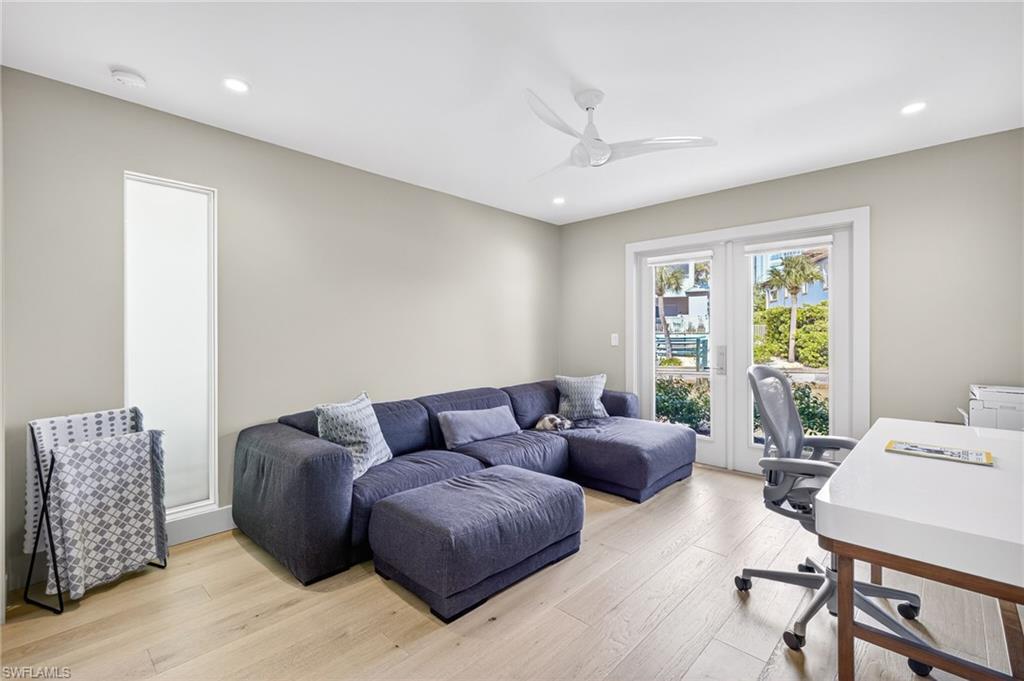 5215 Seashell Avenue Naples, FL 34103 - Photo 36 of 47 a living room with furniture and a large window
