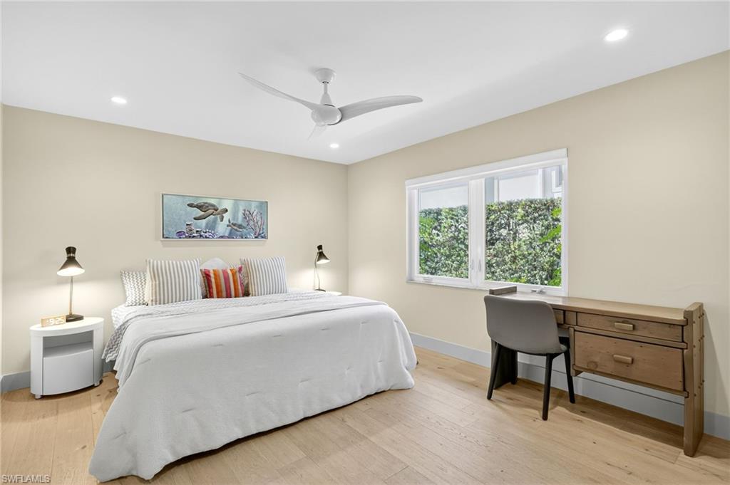 5215 Seashell Avenue Naples, FL 34103 - Photo 39 of 47 a bedroom with a bed and a table