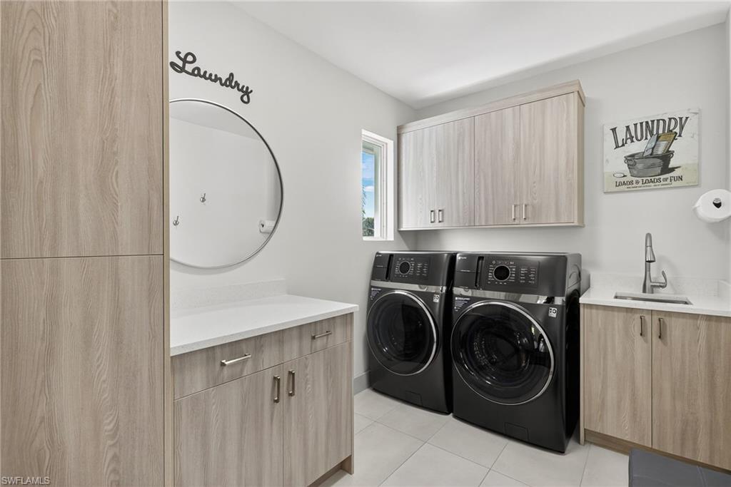 5215 Seashell Avenue Naples, FL 34103 - Photo 40 of 47 a utility room with sink dryer and washer