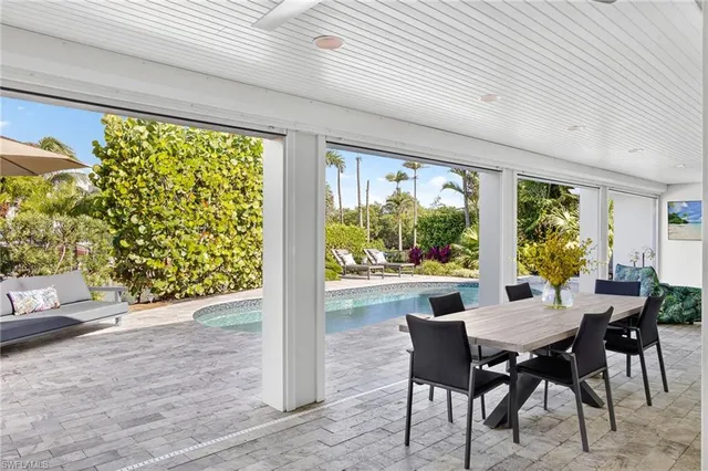 a view of swimming pool with outdoor seating and lake view