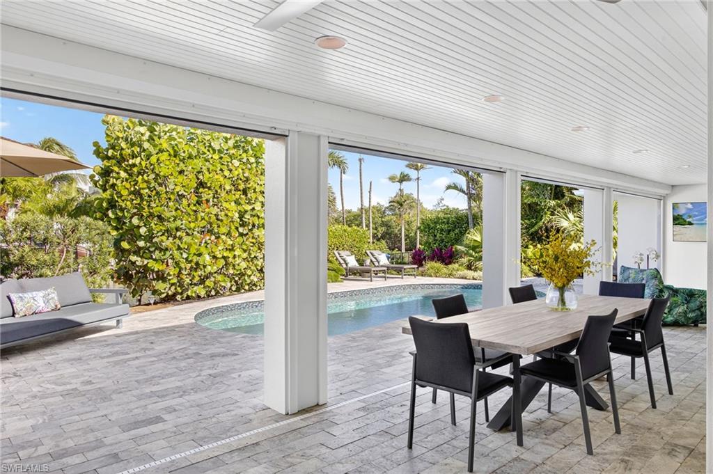 5215 Seashell Avenue Naples, FL 34103 - Photo 42 of 47 a dining room with furniture window and outside view