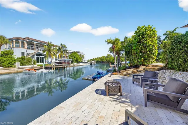 a view of a lake with a table and chairs