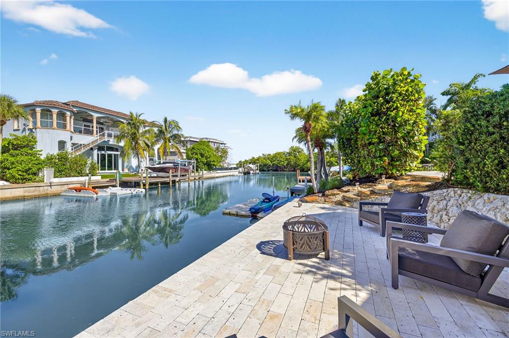 5215 Seashell Avenue Naples, FL 34103 - Photo 43 of 47 a view of swimming pool with outdoor seating and lake view