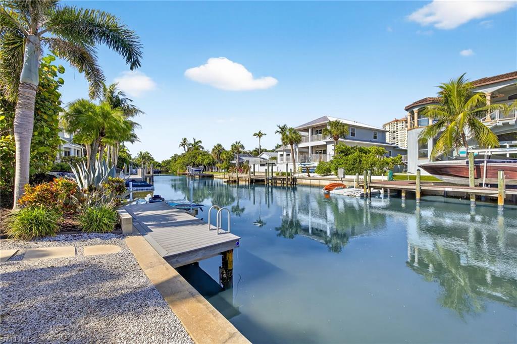 5215 Seashell Avenue Naples, FL 34103 - Photo 44 of 47 a view of a lake with a table and chairs