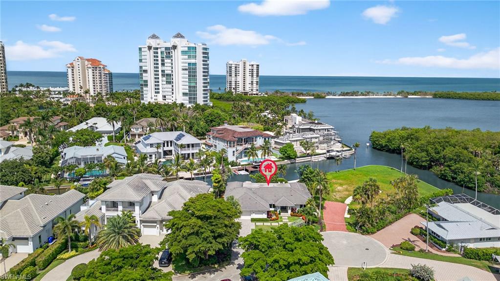 5215 Seashell Avenue Naples, FL 34103 - Photo 45 of 47 an aerial view of a city with lots of residential buildings ocean and mountain view in back