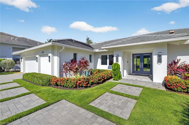 a front view of a house with garden