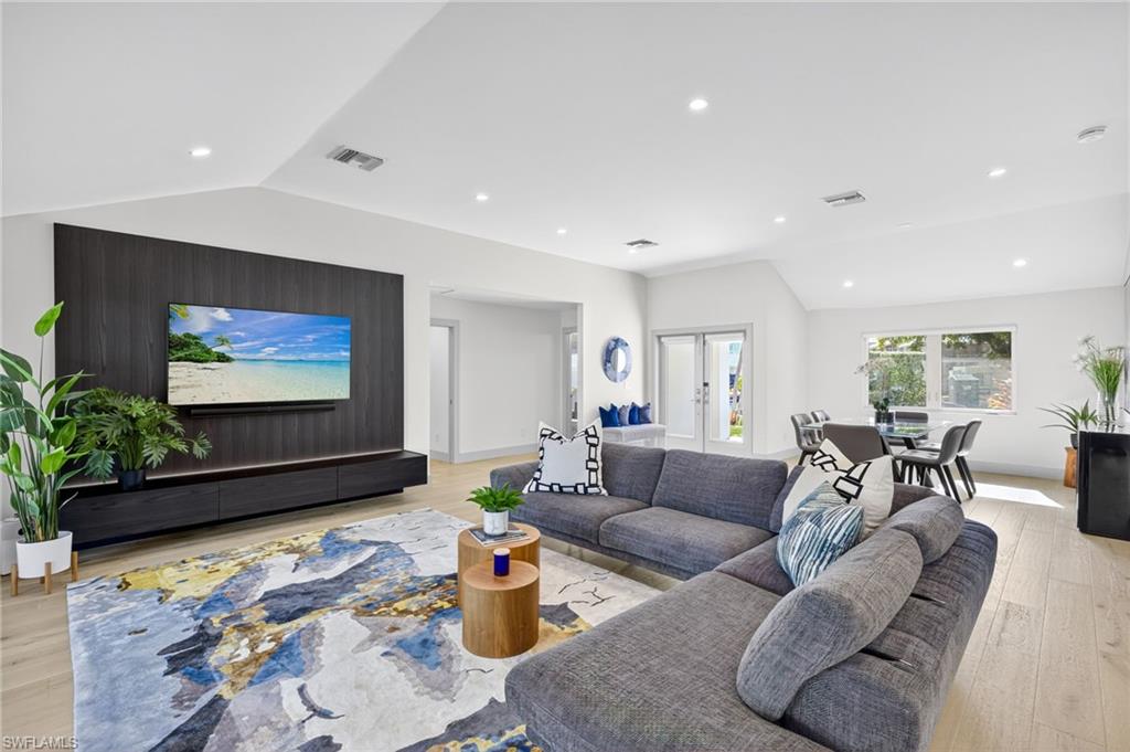 5215 Seashell Avenue Naples, FL 34103 - Photo 6 of 47 a living room with furniture and a flat screen tv