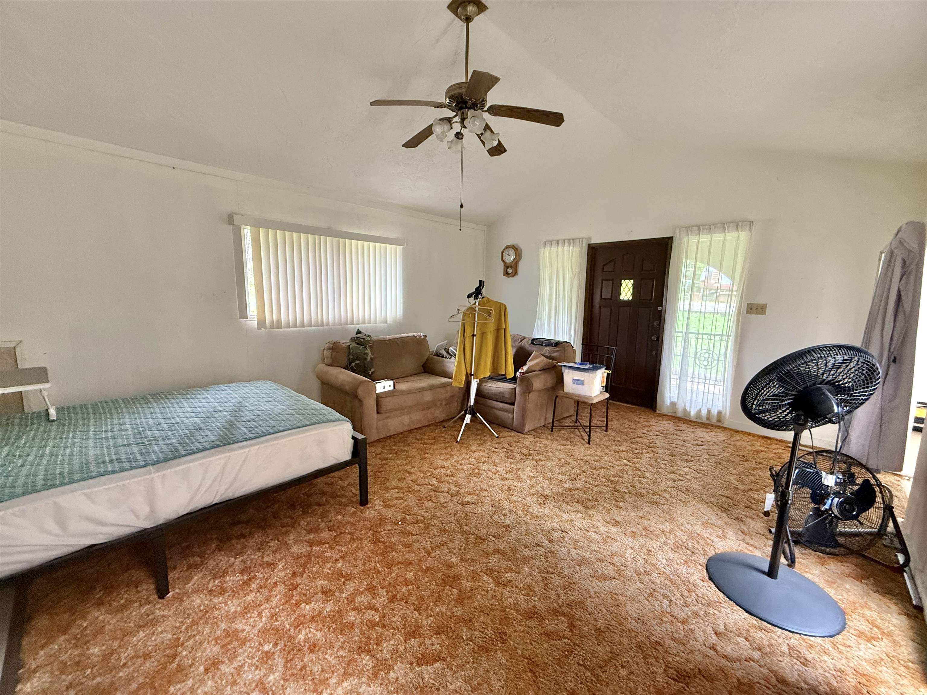 1630 Kauhikoa Road Haiku, HI 96708 - Photo 19 of 48 a living room with furniture a window and a chandelier