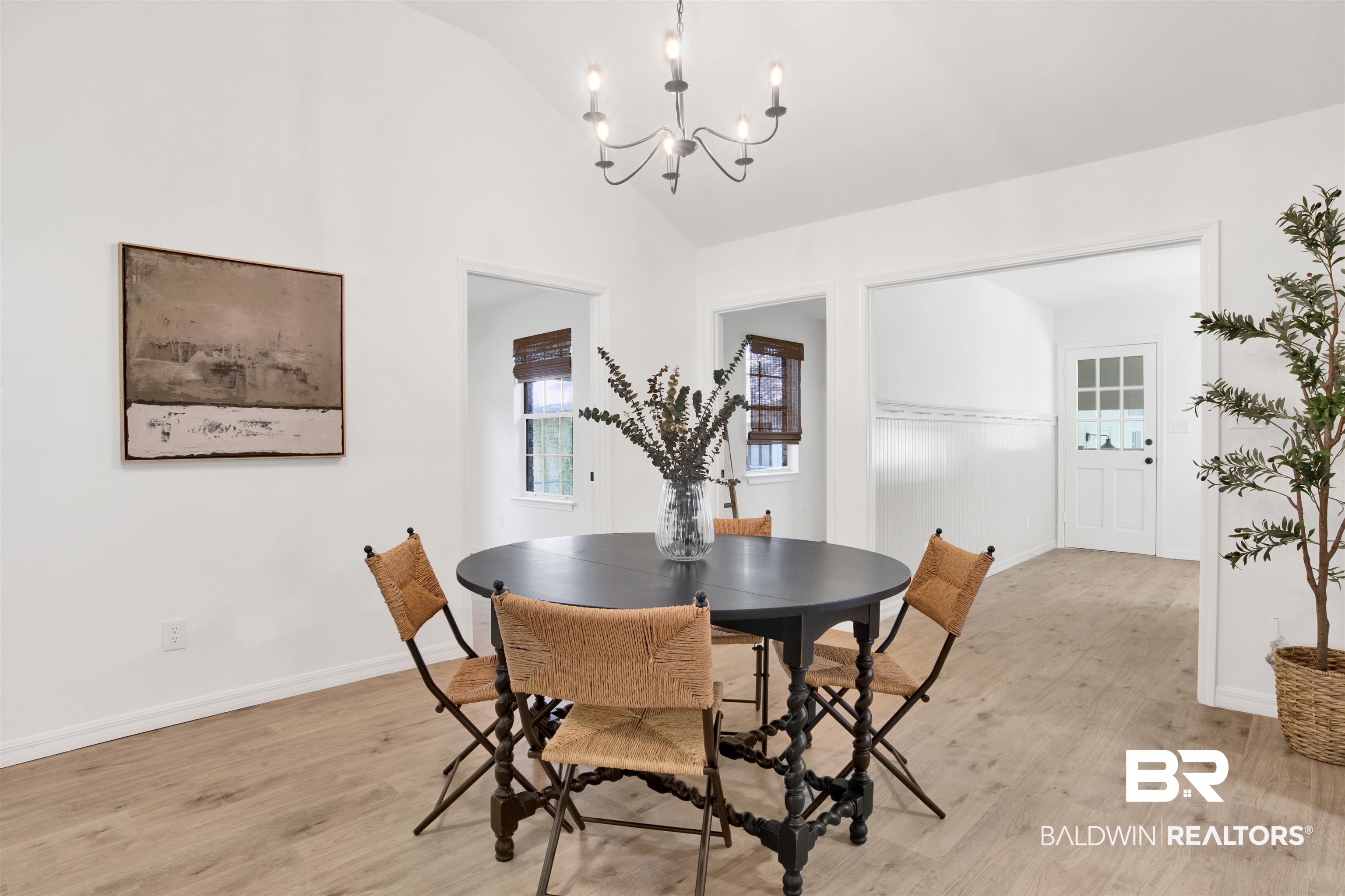 317 Lee Street Chickasaw, AL 36611 - Photo 7 of 40 Dining space with light wood finished floors, lofted ceiling, and a chandelier