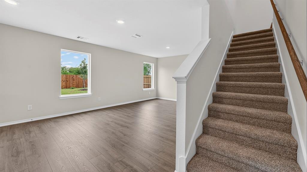 3515 Spring Time Street Forney, TX 75126 - Photo 11 of 29 Open-concept living space featuring wood-finish flooring, recessed lighting, and bright windows
