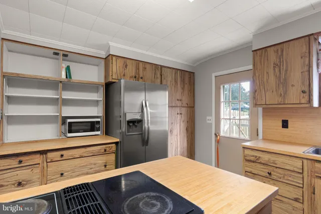 a kitchen with a refrigerator and cabinets