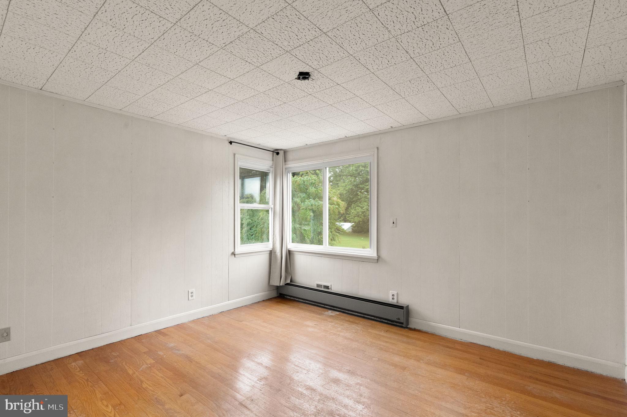 6607 Mt Vista Road Kingsville, MD 21087 - Photo 14 of 26 an empty room with wooden floor and windows