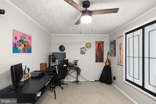 a view of a workspace with furniture and a window