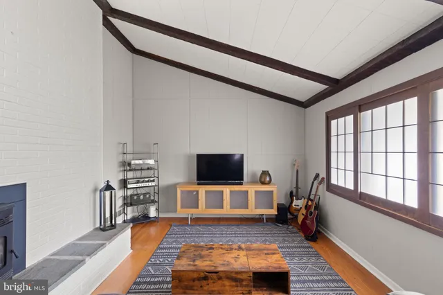 a living room with furniture wooden floor and a flat screen tv