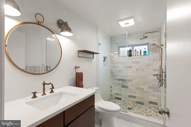 a bathroom with a sink toilet and shower