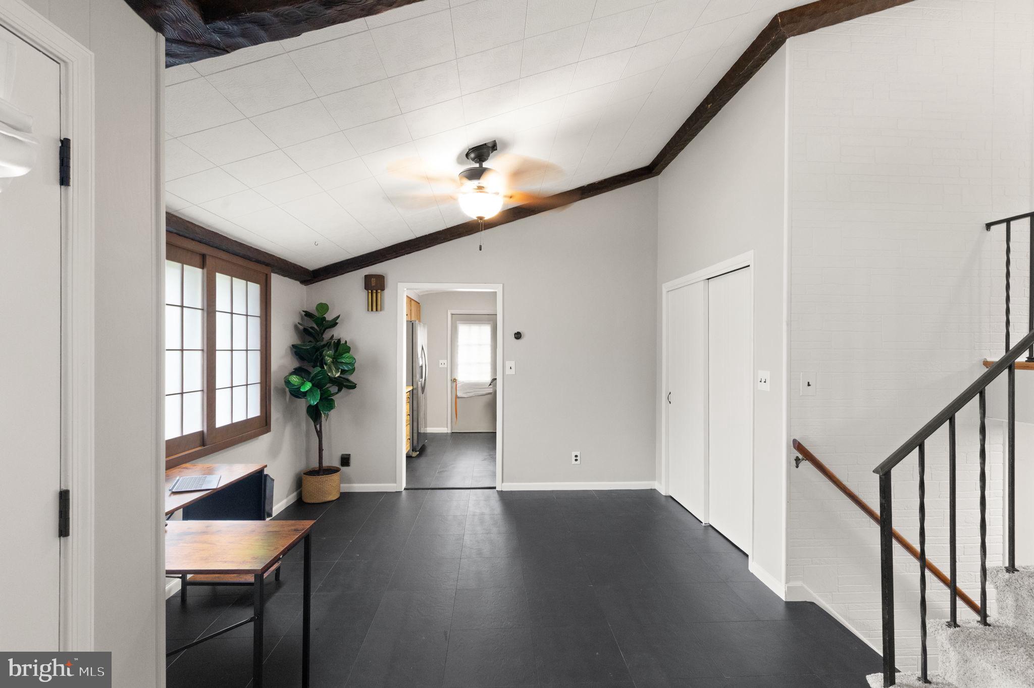 6607 Mt Vista Road Kingsville, MD 21087 - Photo 6 of 26 a hallway with wooden floor windows and a chandelier