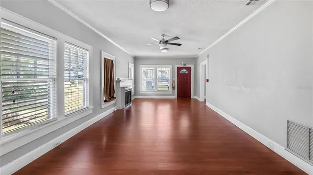 wooden floor in an empty room with a window