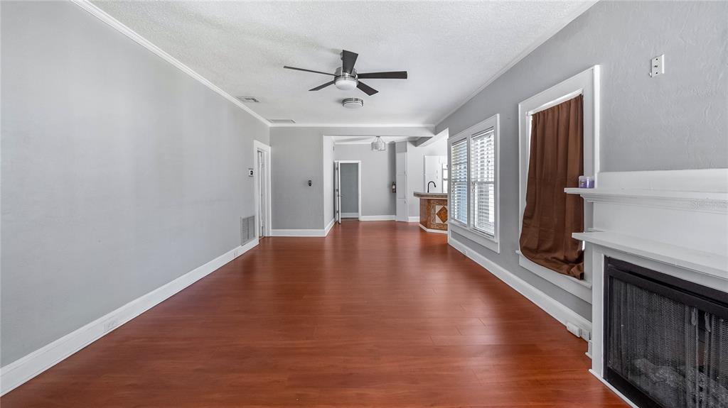 1704 West Main Street Leesburg, FL 34748 - Photo 16 of 37 wooden floor in an empty room with a window