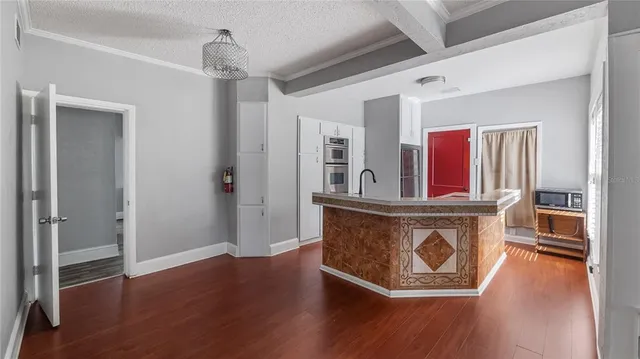 a view of kitchen with stainless steel appliances granite countertop a stove and a refrigerator