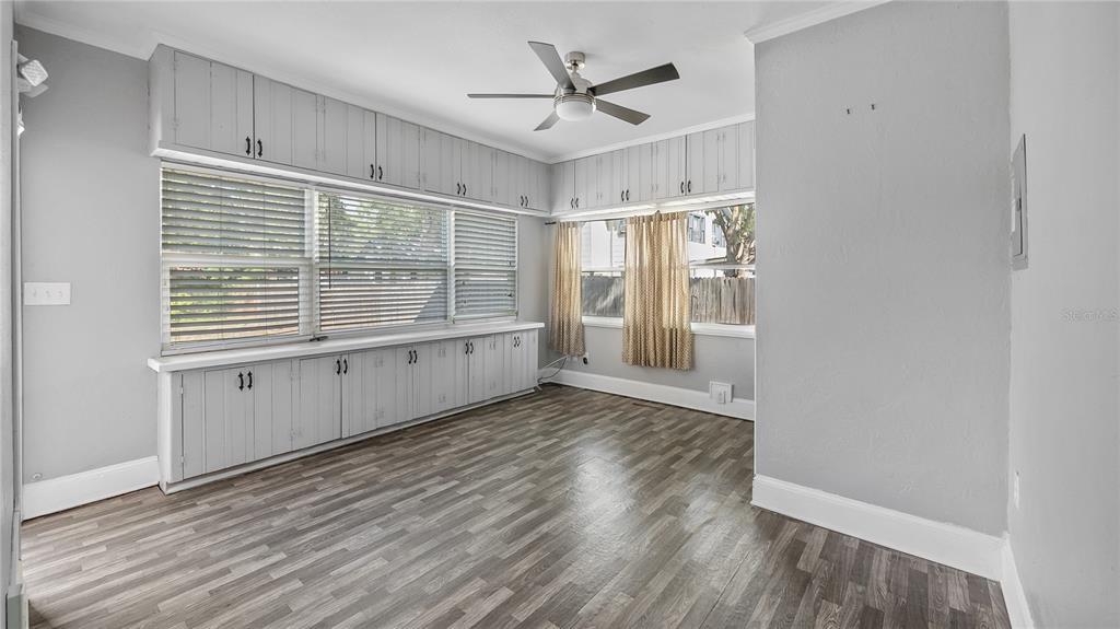 1704 West Main Street Leesburg, FL 34748 - Photo 23 of 37 a view of an empty room with a window and wooden floor
