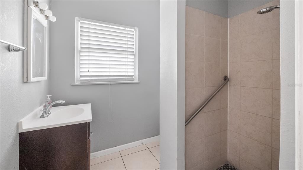 1704 West Main Street Leesburg, FL 34748 - Photo 24 of 37 a bathroom with a sink and a mirror