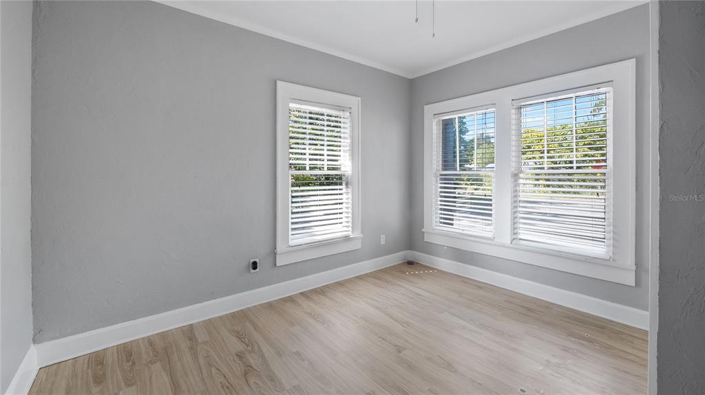 1704 West Main Street Leesburg, FL 34748 - Photo 25 of 37 a view of an empty room with wooden floor and a window