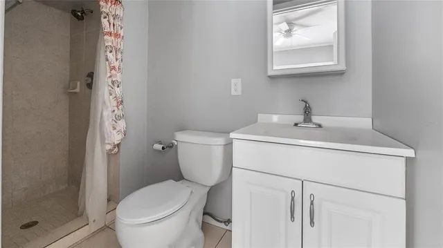 a white toilet sitting next to a bathroom sink