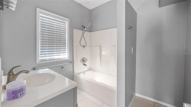 a bathroom with a sink a mirror and a bathtub