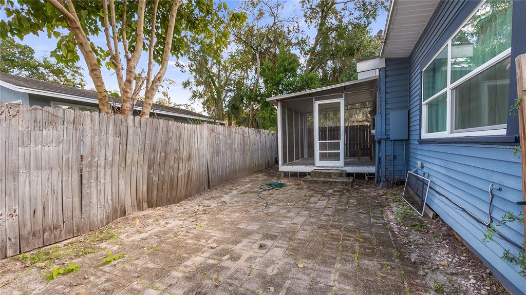 1704 West Main Street Leesburg, FL 34748 - Photo 30 of 37 a view of a backyard with wooden fence and large trees