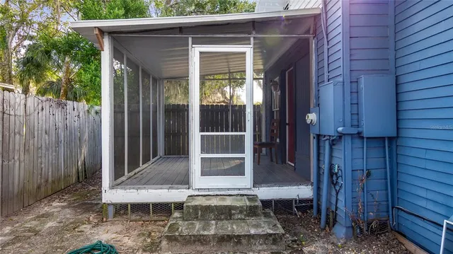 a view of a house with a door and wooden walls