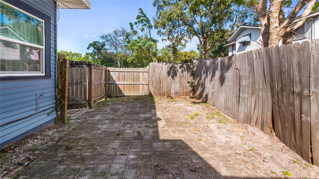 1704 West Main Street Leesburg, FL 34748 - Photo 32 of 37 a view of a backyard with wooden fence and large trees