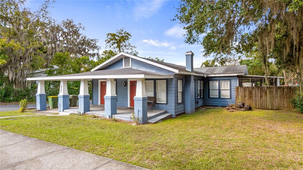 1704 West Main Street Leesburg, FL 34748 - Photo 6 of 37 a view of a house with a yard balcony and wooden fence