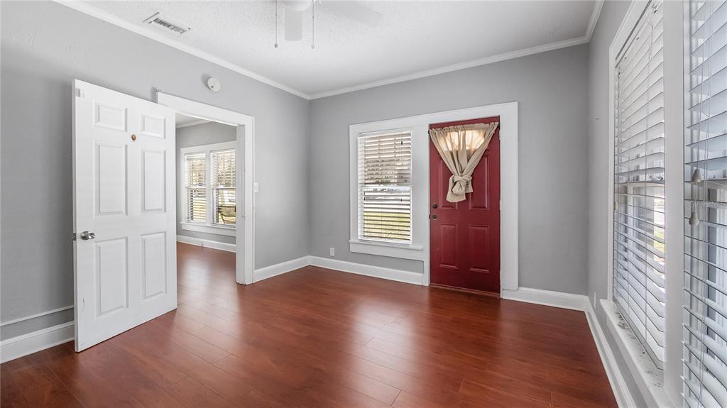 1704 West Main Street Leesburg, FL 34748 - Photo 9 of 37 wooden floor in an empty room with a window