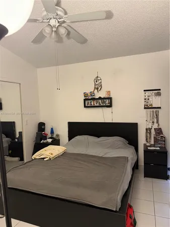 a bedroom with a bed and ceiling fan