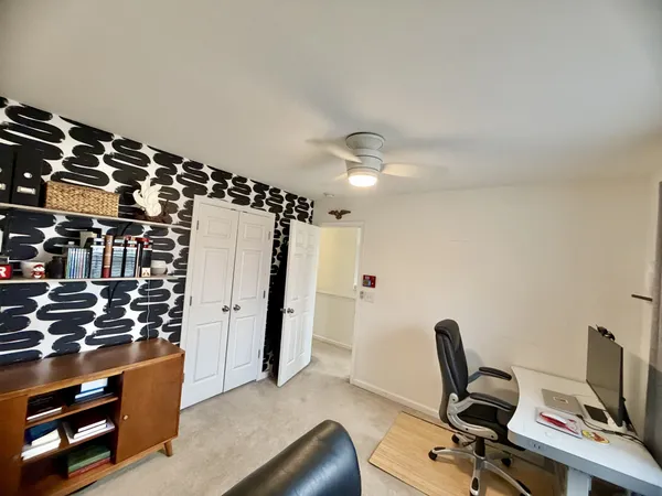 a view of a workspace with furniture and gym equipment